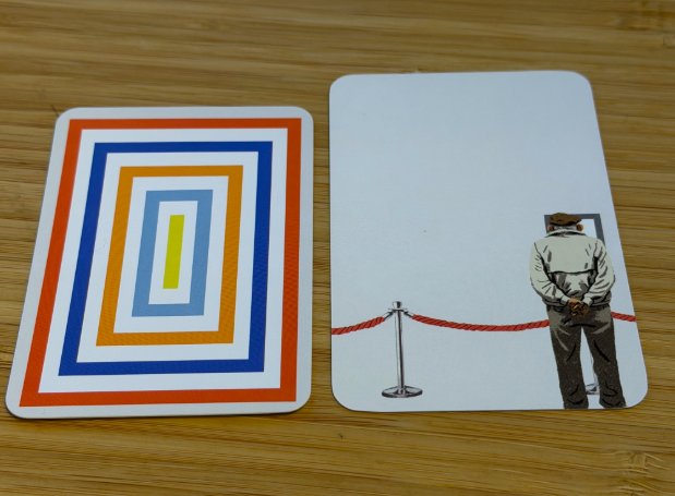 Card backs: new edition on the left, 2014 first edition on the right